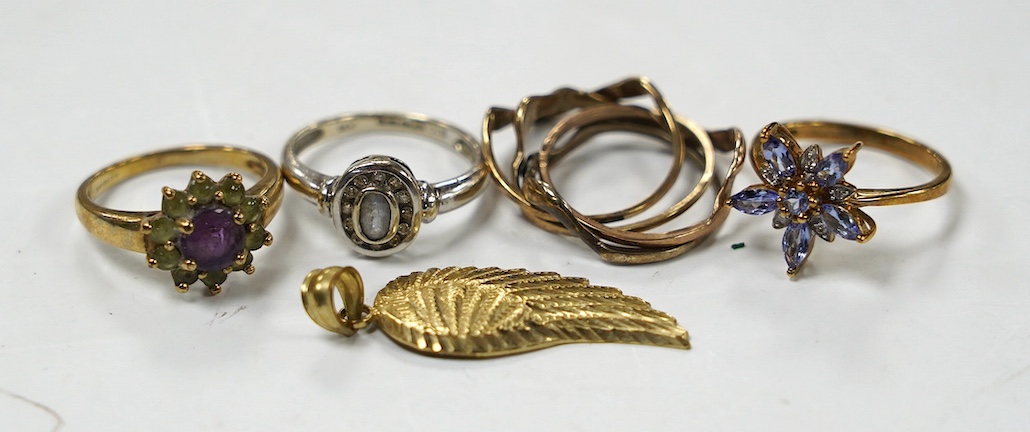 A modern 14k and gem set cluster ring, size L, gross weight 2.5 grams, together with three assorted 9ct rings, including gem set and a 9k leaf pendant, gross weight 10.8 grams. Condition - poor to fair